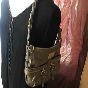 Relic brand shoulder handbag.  Has a Silvery brownish metallic color.
